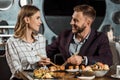 Happy beautiful couple amorously looking at each other while having dinner Royalty Free Stock Photo