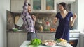 Happy beautiful couple dancing rocknroll while cook on the kitchen at home