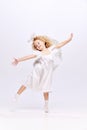 Happy, beautiful, cute baby girl child in image f angel dancing and handing fun isolated over white studio background Royalty Free Stock Photo