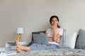 Happy beautiful dreamy hispanic woman dreaming, sitting on sofa.