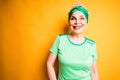 Happy beautiful elderly woman in sports bandage and t-shirt smiling getting ready for training Royalty Free Stock Photo