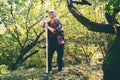 Happy beautiful elderly woman 60 years old working in her garden using a rake Royalty Free Stock Photo