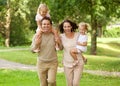 Happy beautiful family of four running in park Royalty Free Stock Photo