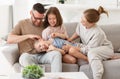 Happy beautiful family having fun and playing while relaxing on sofa in living room Royalty Free Stock Photo