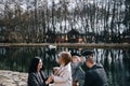 Happy beautiful family holding hands and walking by seashore on autumn day.