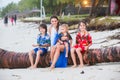 Happy beautiful fashion family, children, dressed in hawaiian shirts, together on the beach on sunset Royalty Free Stock Photo