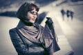 Happy beautiful fashion woman in black leather coat and scarf Royalty Free Stock Photo