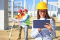 Female architect with tablet and construction engineers Royalty Free Stock Photo