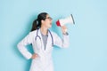 Happy beautiful female doctor using loudspeaker