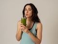 Happy beautiful fit sport woman smiling and drinking healthy fresh vegetable detox smoothie Royalty Free Stock Photo