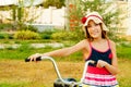 Happy beautiful girl with bicycle on sunset