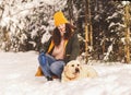 Happy beautiful girl with her white dog Labrador in winter in nature Royalty Free Stock Photo