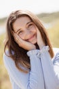 Happy beautiful girl holding her cheeks with a laugh, looking at the camera. Pretty young woman clean fresh skin Royalty Free Stock Photo