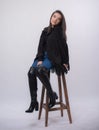 Happy beautiful girl model in black dress posing in studio isolated on white background,Teen girl in in blue jeans and black boots