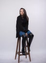 Happy beautiful girl model in black dress posing in studio isolated on white background,Teen girl in in blue jeans and black boots