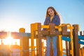 Happy beautiful girl playing on the beach playground against sunset sky Royalty Free Stock Photo