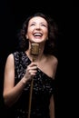 Happy beautiful girl singer laughing holding retro microphone Royalty Free Stock Photo