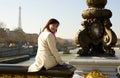 Happy beautiful girl sitting on bridge balustrade Royalty Free Stock Photo