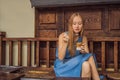 Happy beautiful girl sitting on stairs in park and drinking ice coffee Royalty Free Stock Photo