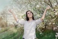 Happy Beautiful Girl in Spring Flowers Landscape