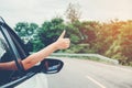 Happy beautiful girl traveling in a hatchback car Royalty Free Stock Photo