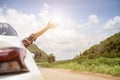 Happy beautiful girl traveling in a hatchback car Royalty Free Stock Photo