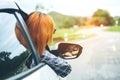 Happy beautiful girl traveling in a hatchback car Royalty Free Stock Photo