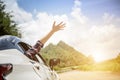 Happy beautiful girl traveling in a hatchback car Royalty Free Stock Photo