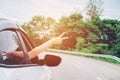 Happy beautiful girl traveling in a hatchback car Royalty Free Stock Photo