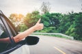 Happy beautiful girl traveling in a hatchback car Royalty Free Stock Photo