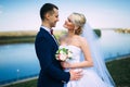 happy and beautiful groom and bride tender kiss at spring outdoo Royalty Free Stock Photo