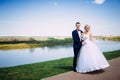 happy and beautiful groom and bride tender kiss at spring outdoo Royalty Free Stock Photo