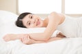 Happy beautiful health asian woman feel carefree lying on bed