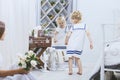 Happy beautiful little girl in a white dress at home of a large Royalty Free Stock Photo