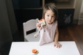 Happy beautiful little two-year-old girl is holding educational toy in her hands. Royalty Free Stock Photo