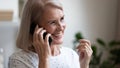 Happy beautiful mature woman making phone call close up