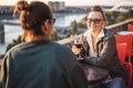 Happy beautiful mature woman in glasses 60 years old sitting in a cafe with her girlfriend drinking wine Royalty Free Stock Photo