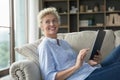 Happy beautiful middle aged woman holding tablet computer Royalty Free Stock Photo