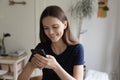 Happy beautiful millennial girl engaged in using mobile phone Royalty Free Stock Photo