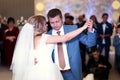 Happy beautiful newlyweds dance in restaurant