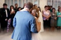 Happy beautiful newlyweds dance in restaurant