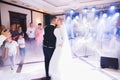 Happy beautiful newlyweds dancing in the restaurant