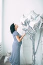 Happy beautiful pregnant caucasian woman with big belly in dress in the child room with balloons, future parrents Royalty Free Stock Photo