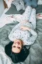 Happy beautiful pregnant caucasian woman with big belly in pajamas in the bedroom, future parrents, waiting for a child Royalty Free Stock Photo