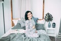 Happy beautiful pregnant caucasian woman with big belly in pajamas in the bedroom, future parrents, waiting for a child Royalty Free Stock Photo