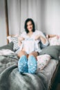 Happy beautiful pregnant caucasian woman with big belly in white underwear in the bedroom, future parrents, waiting for Royalty Free Stock Photo