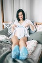 Happy beautiful pregnant caucasian woman with big belly in white underwear in the bedroom, future parrents, waiting for Royalty Free Stock Photo