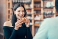 Happy, beautiful and relaxed woman eating on a date at a restaurant with her partner on the weekend. Young and Royalty Free Stock Photo