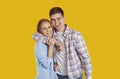 Studio portrait of cheerful siblings or teen couple hugging each other and smiling Royalty Free Stock Photo