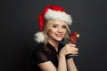 Happy beautiful Santa woman smiling on black background. Christmas holiday and New Year party portrait Royalty Free Stock Photo